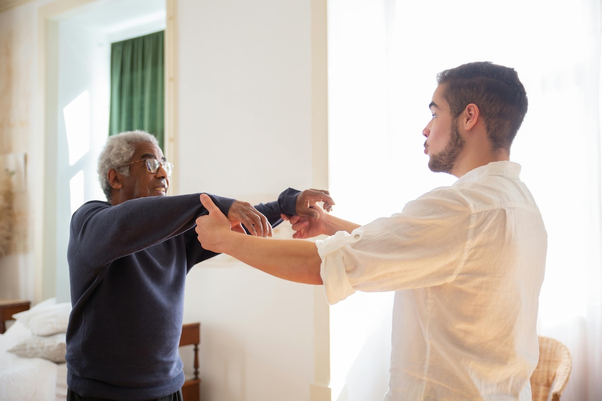 Adult child holding an aging parent's hand