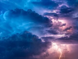 Dark storm clouds with lightning surrounding a bright center