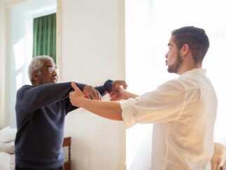 Adult child holding an aging parent's hand