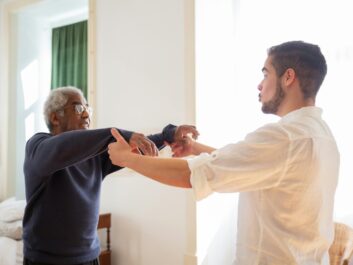 Adult child holding an aging parent's hand